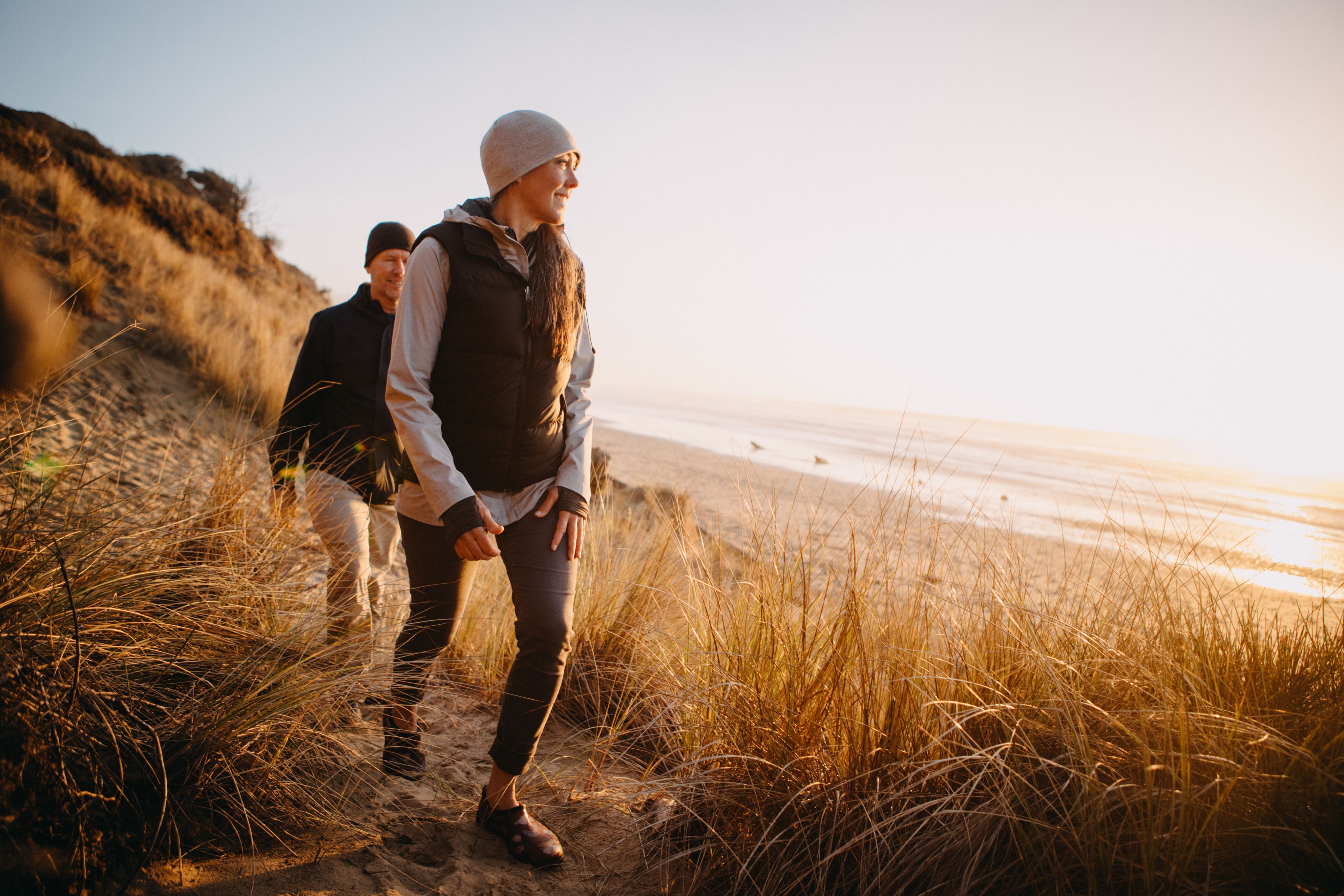 A couple hiking by the beach.