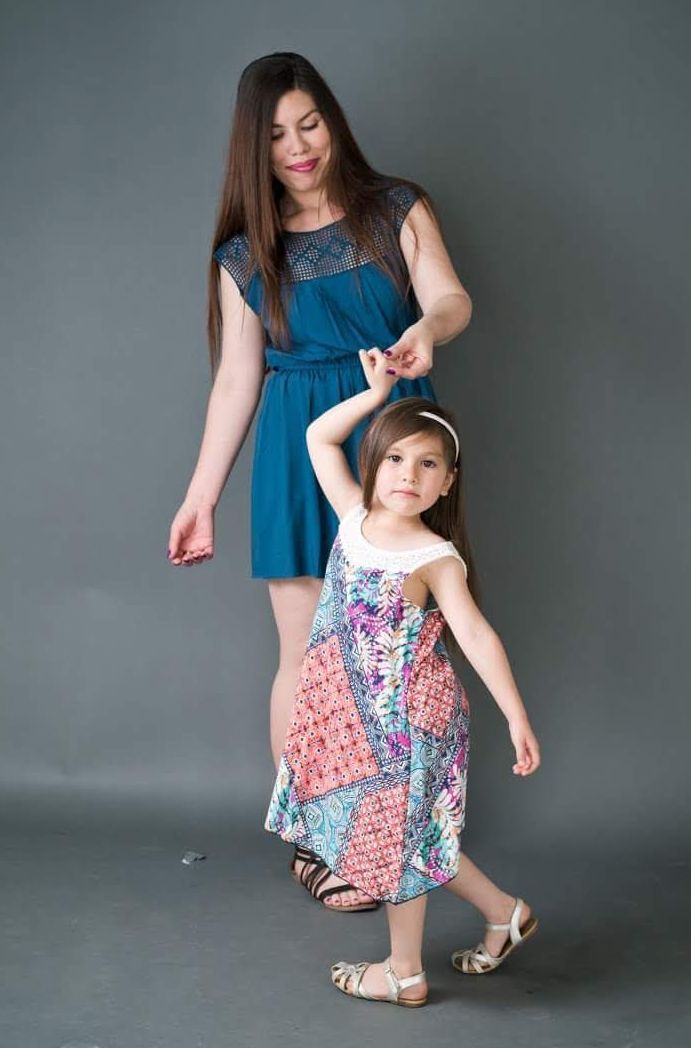 A woman and her daughter dancing.