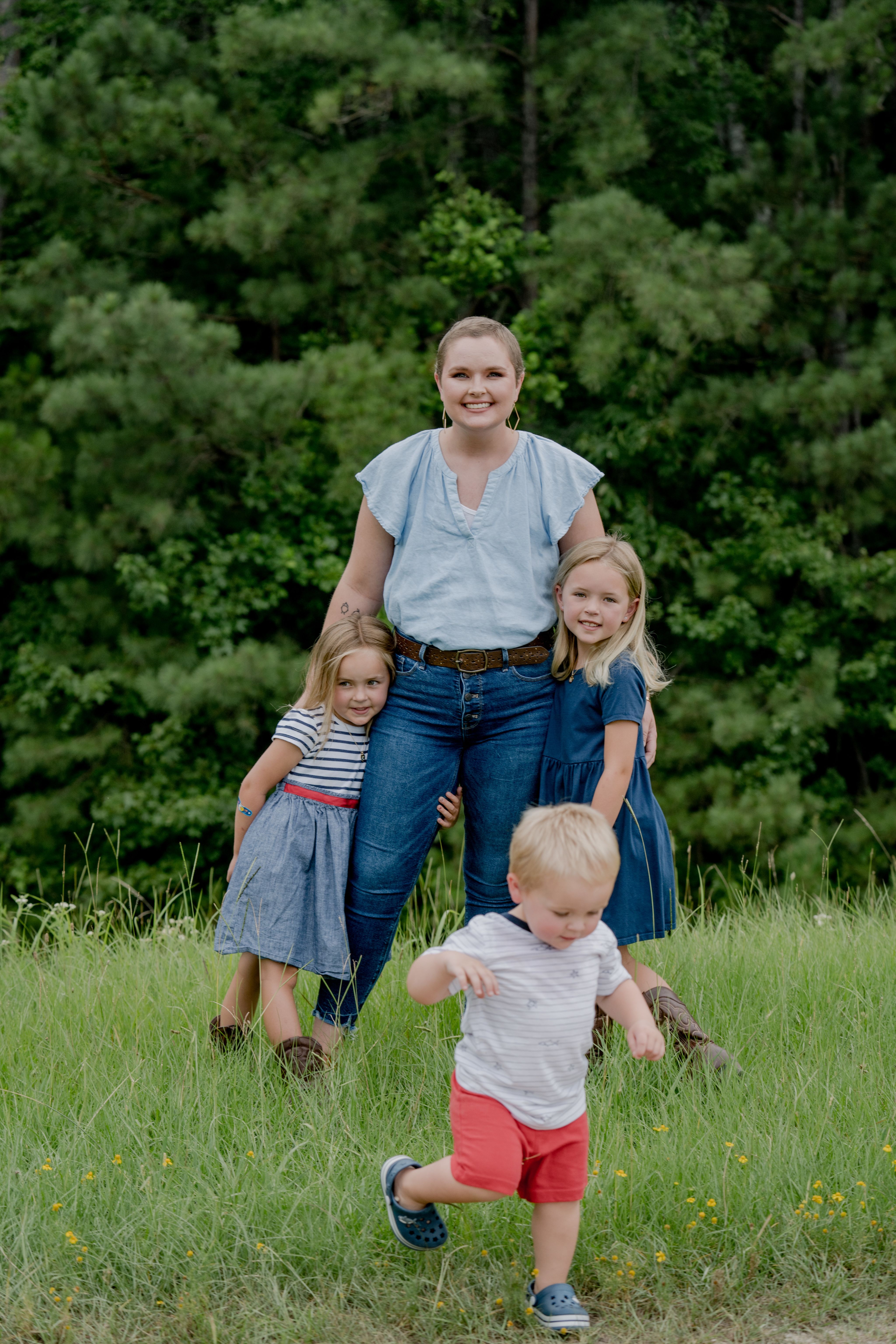 A woman with her children outside in nature.
