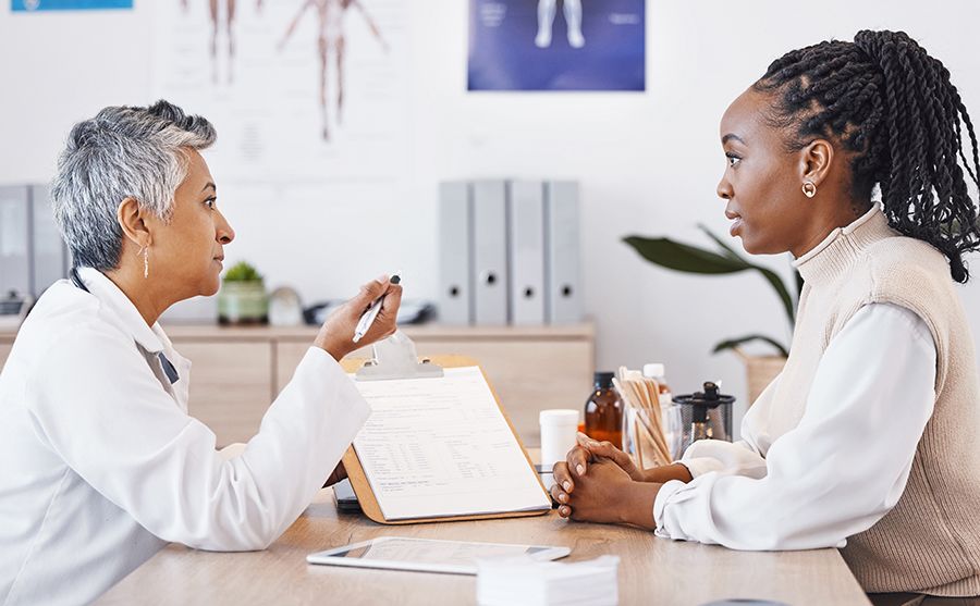 A woman speaking with her oncologist about metastatic breast cancer.