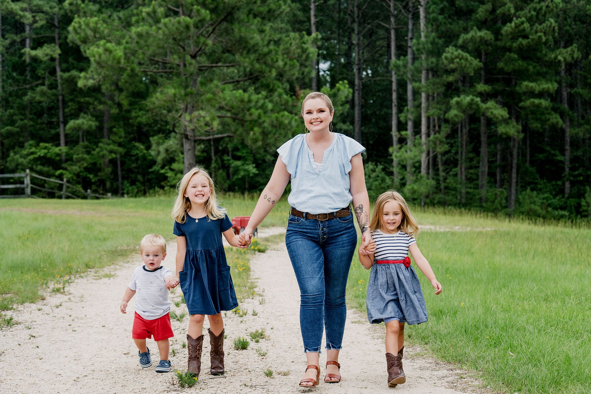 A woman walking with her children in nature. 