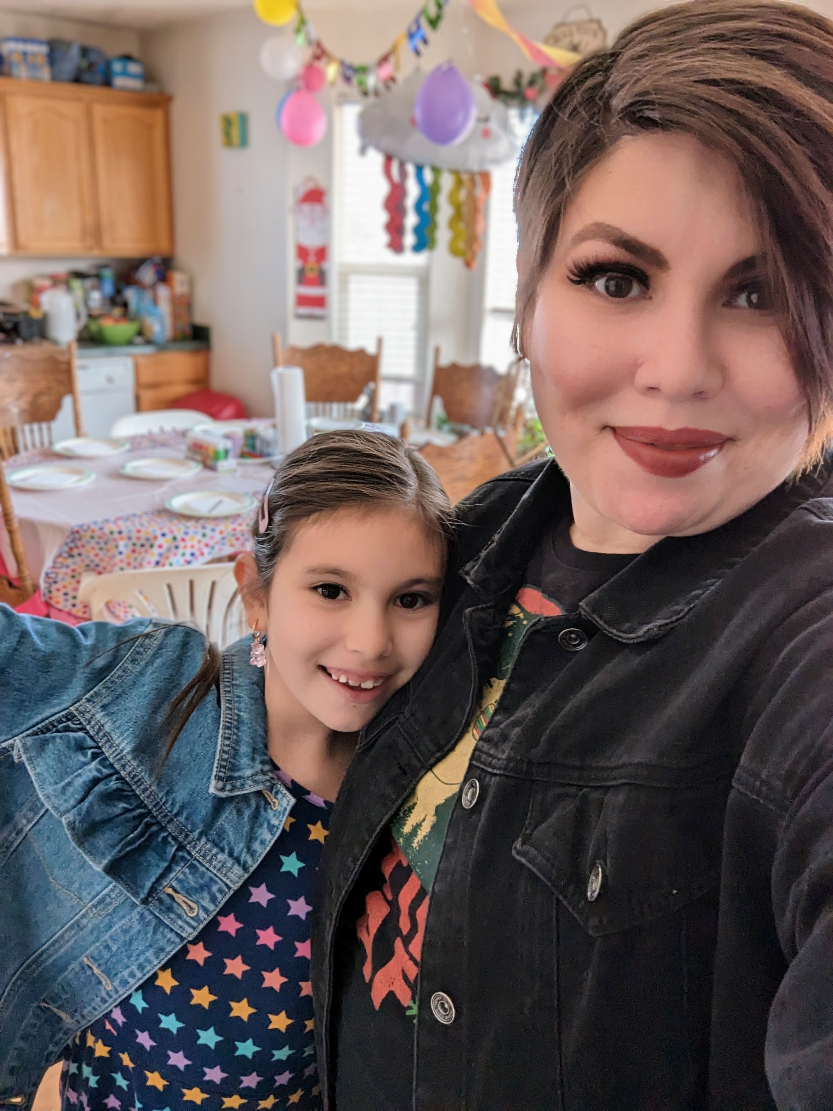 A woman celebrating with her daughter.
