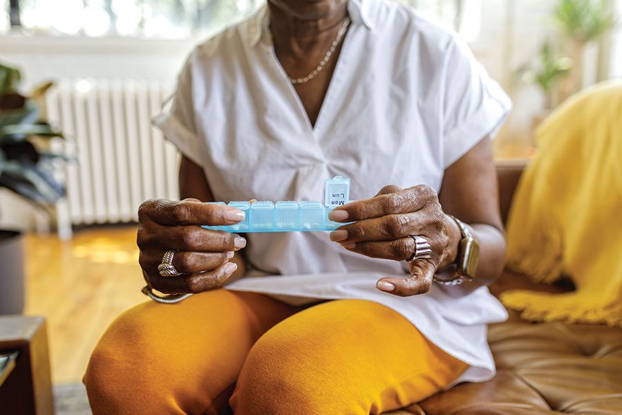 A woman with gout taking her daily prescription medication. 