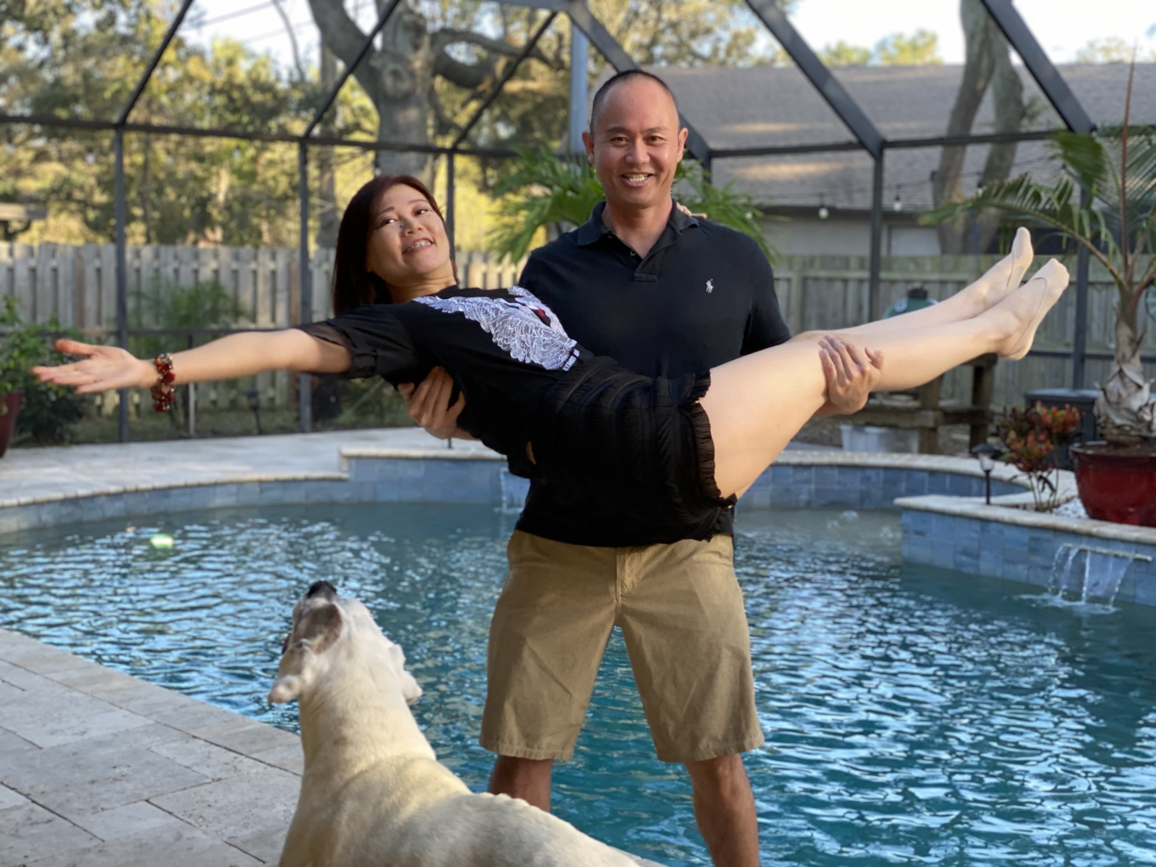 A man with gout holding his wife in front of a pool.