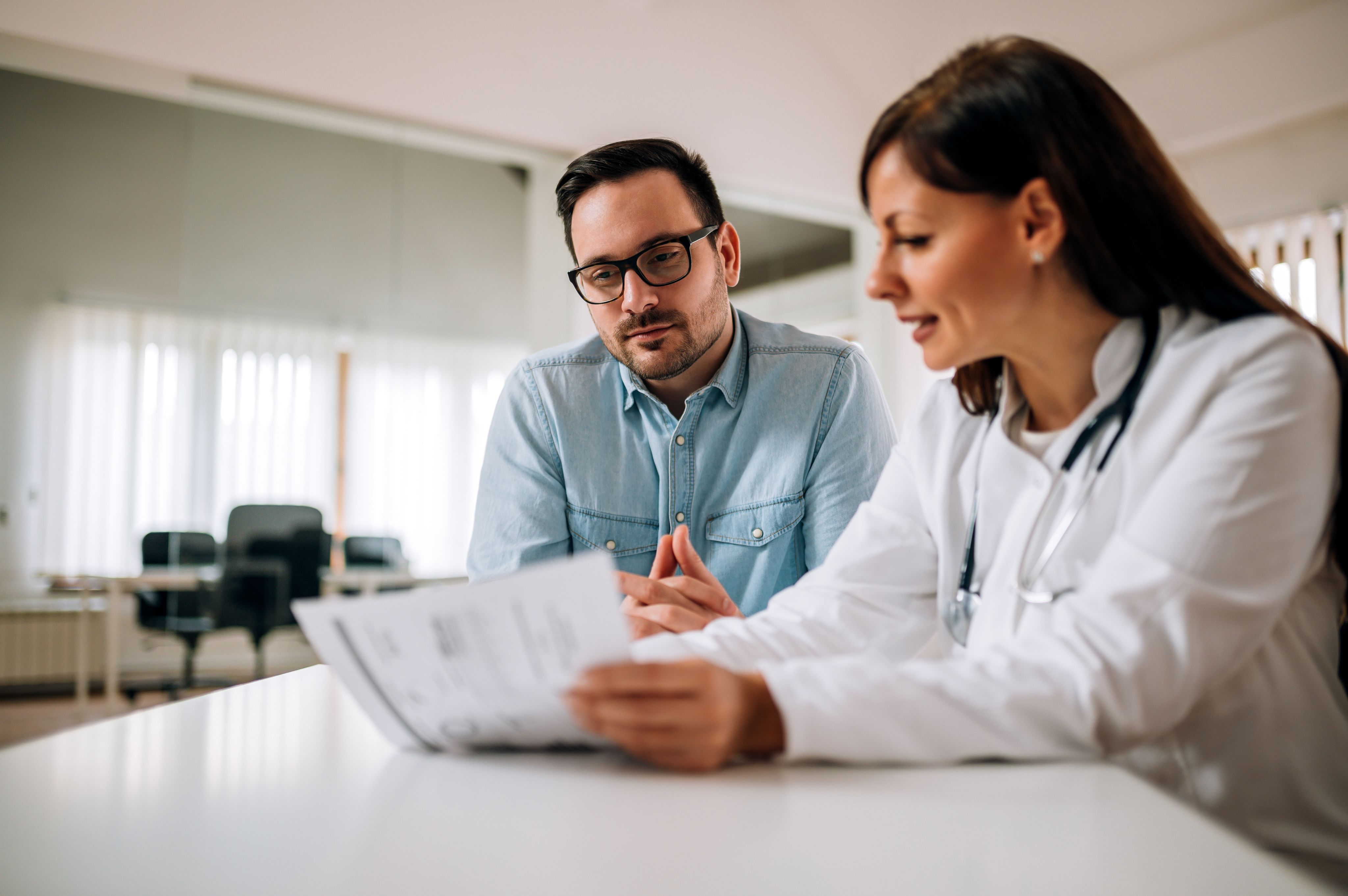 an image of a man with his doctor discussing his gout diagnosis and medical plan.
