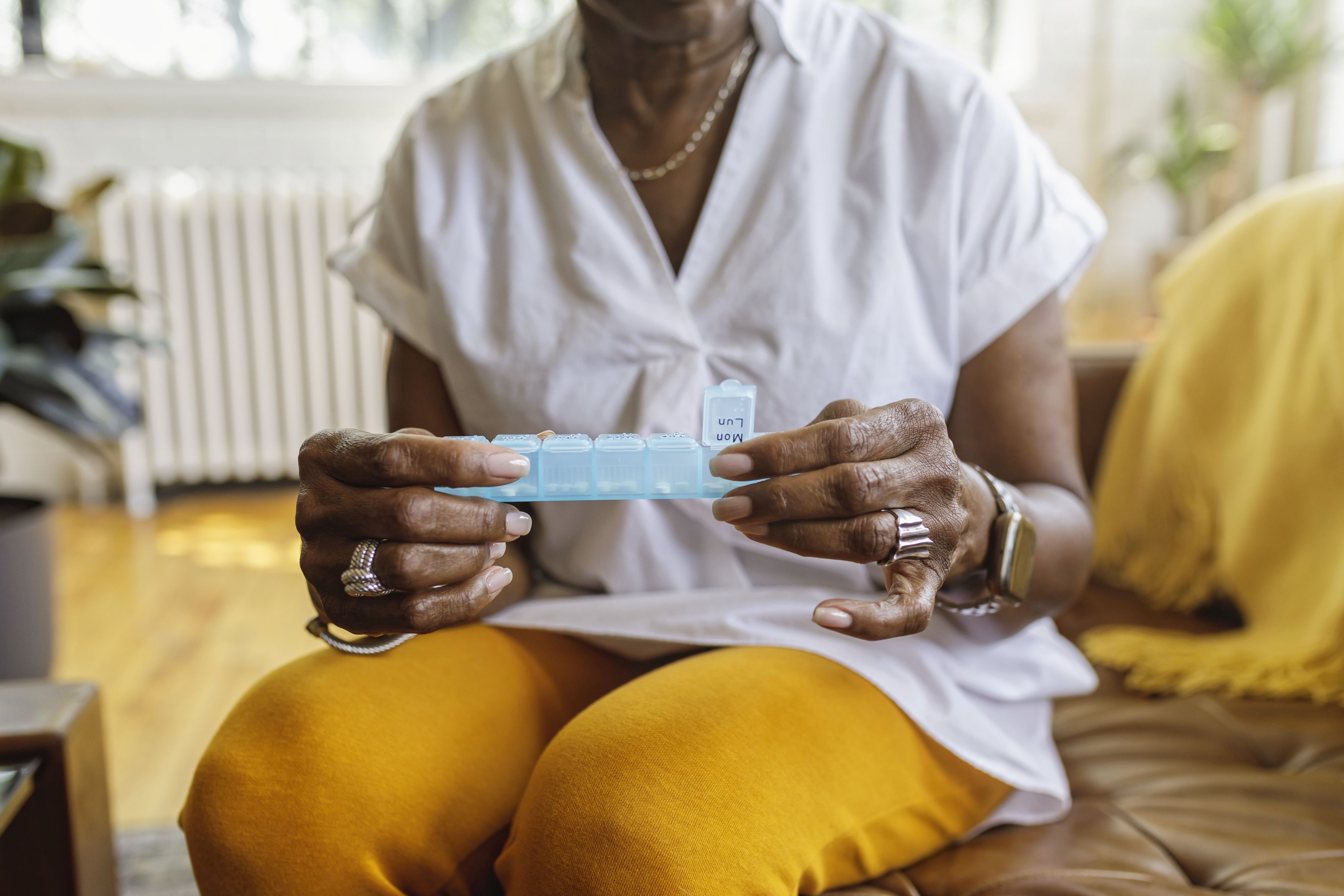 An image of a woman with gout taking her daily medication.