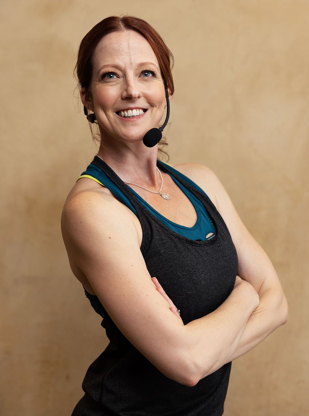 A workout instructor smiling and posing. 