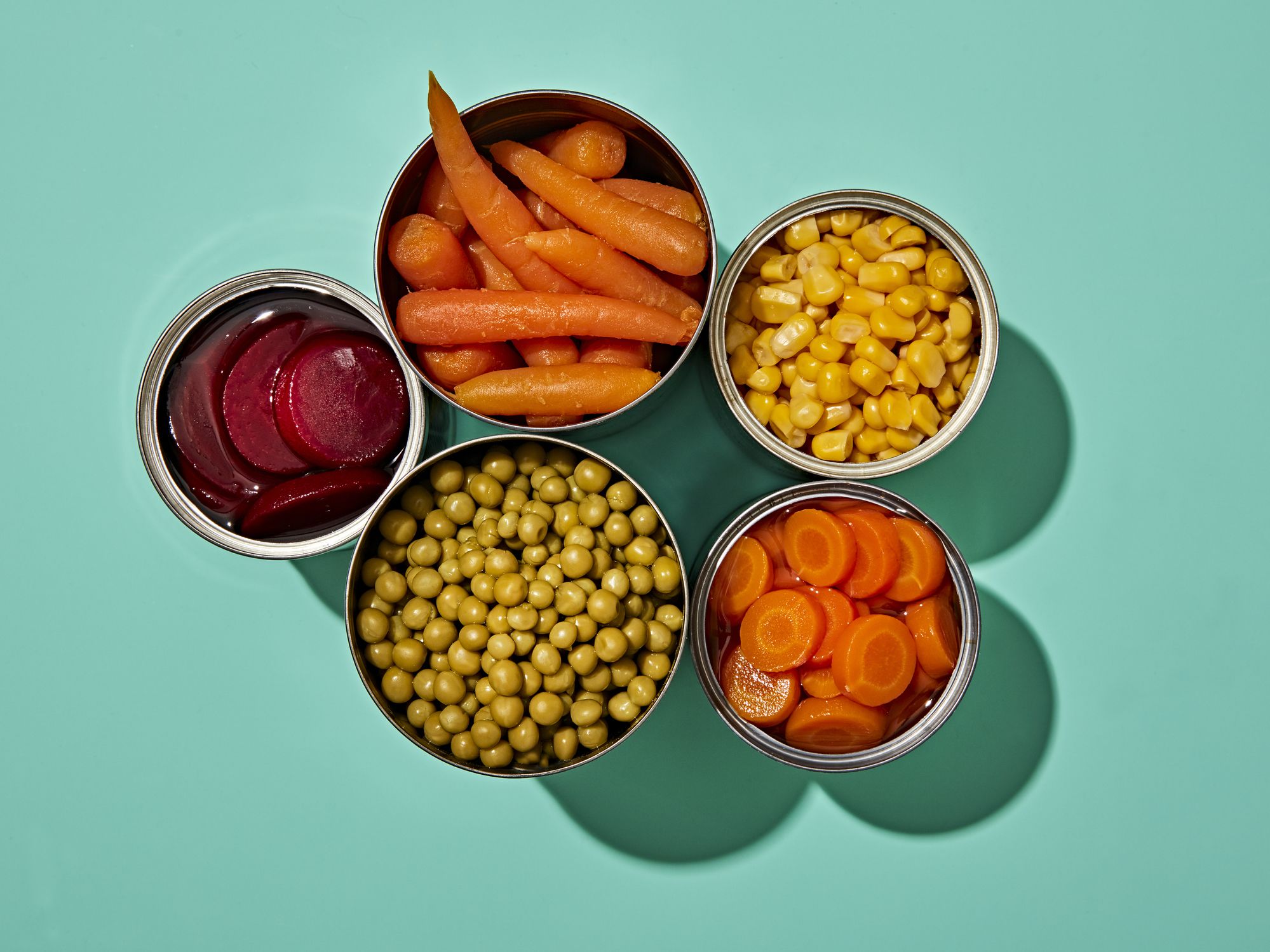 Bowls of vegetables, (beets, carrots, corn, garbanzo beans). 