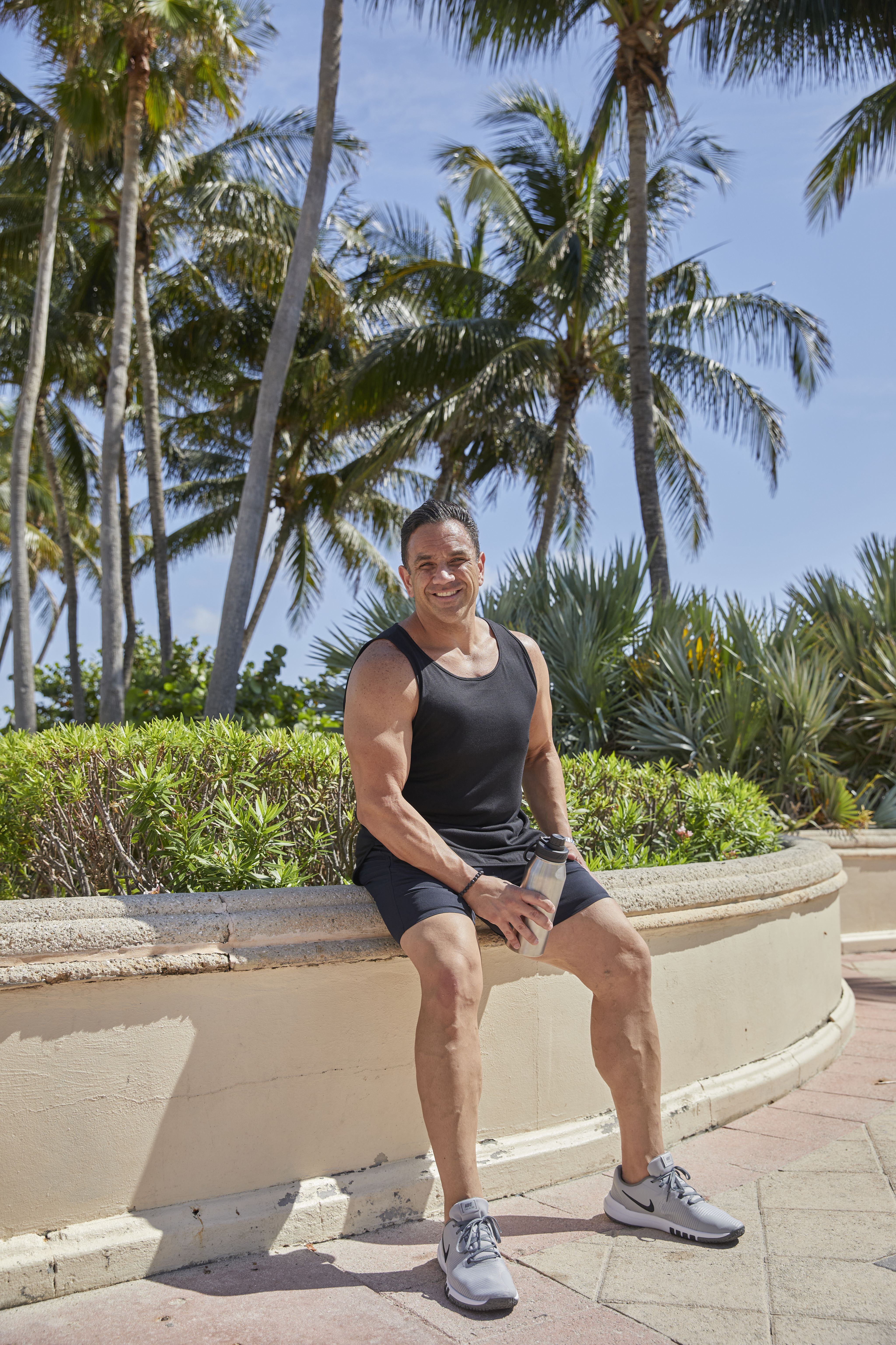 A healthy man outside working out by the beach.