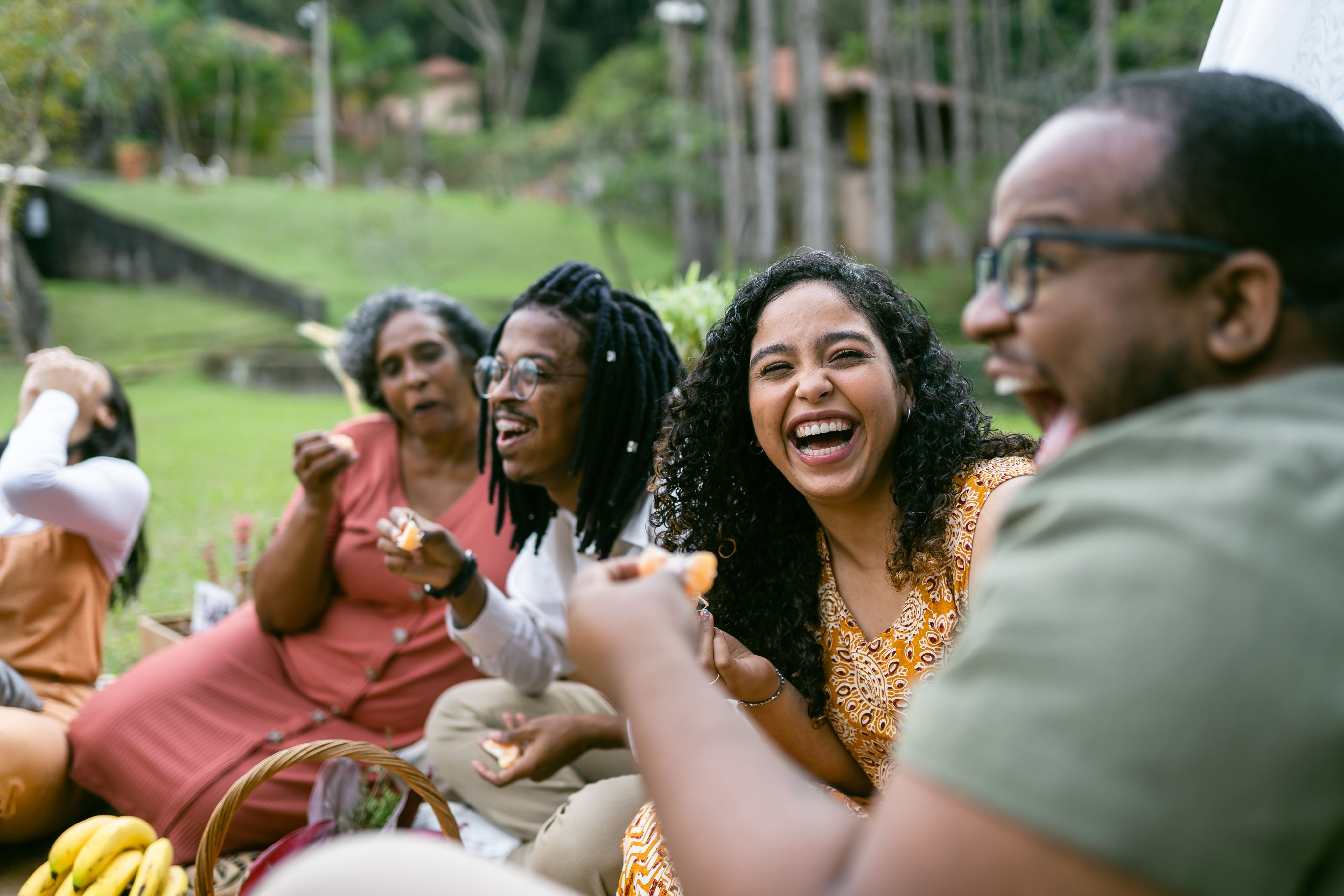 A group of friends and family smiling at a picnic