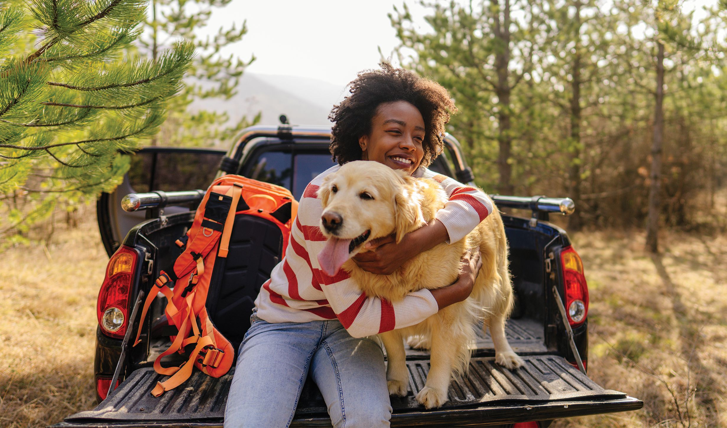An image of a woman smiling with her dog.