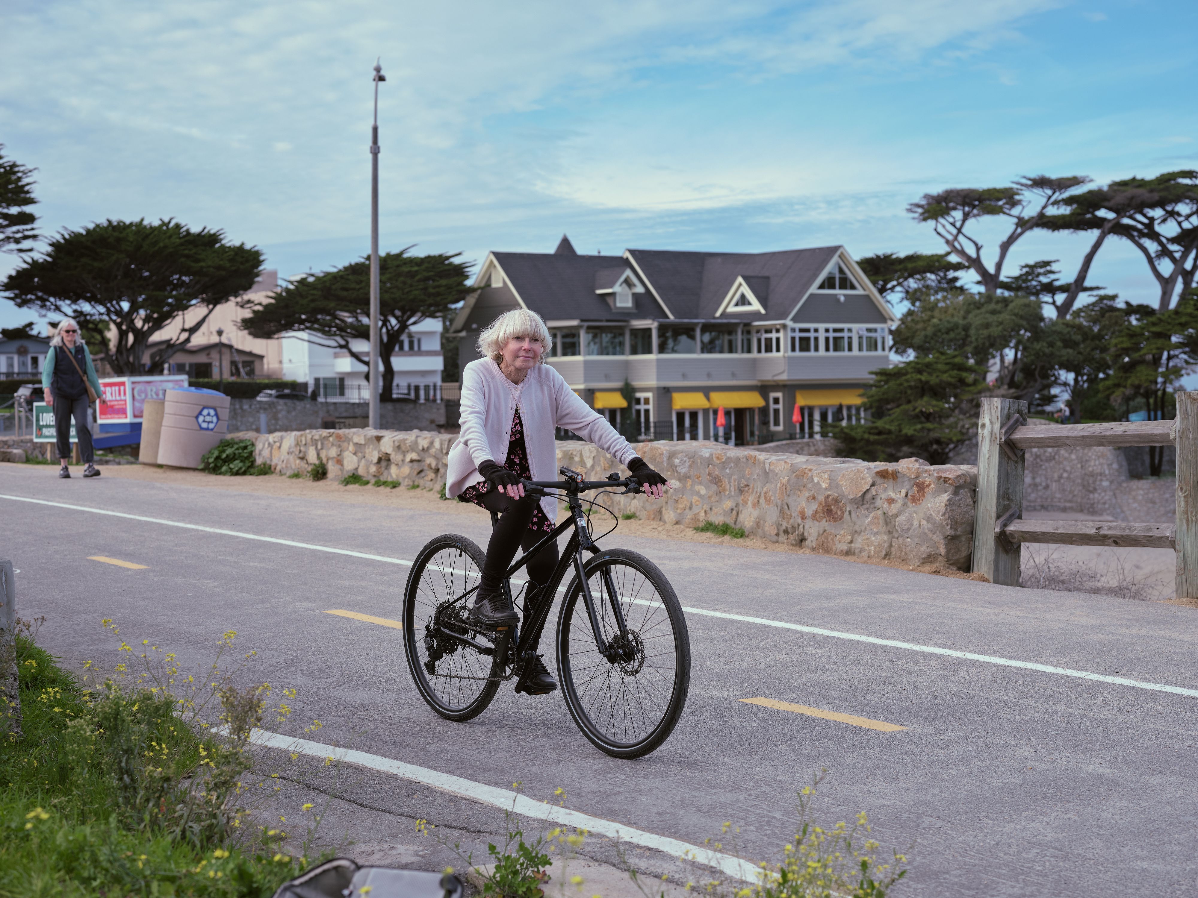 An image of a woman riding a bike.