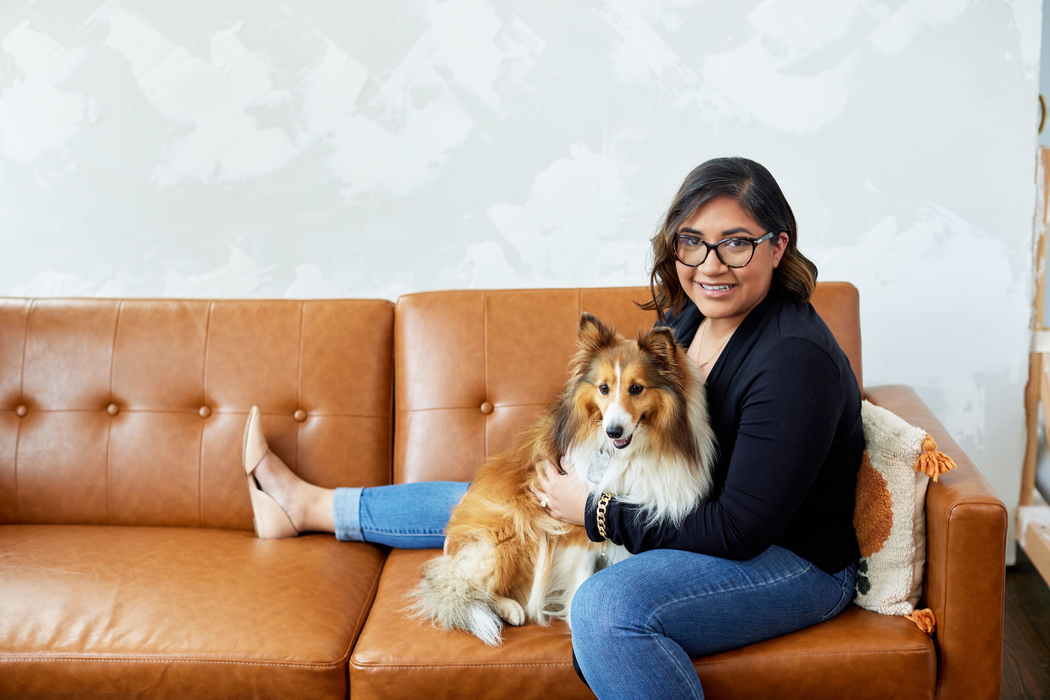 Alejandra (Ally) Lavalley who is lowering her cholesterol with her puppy on the couch.