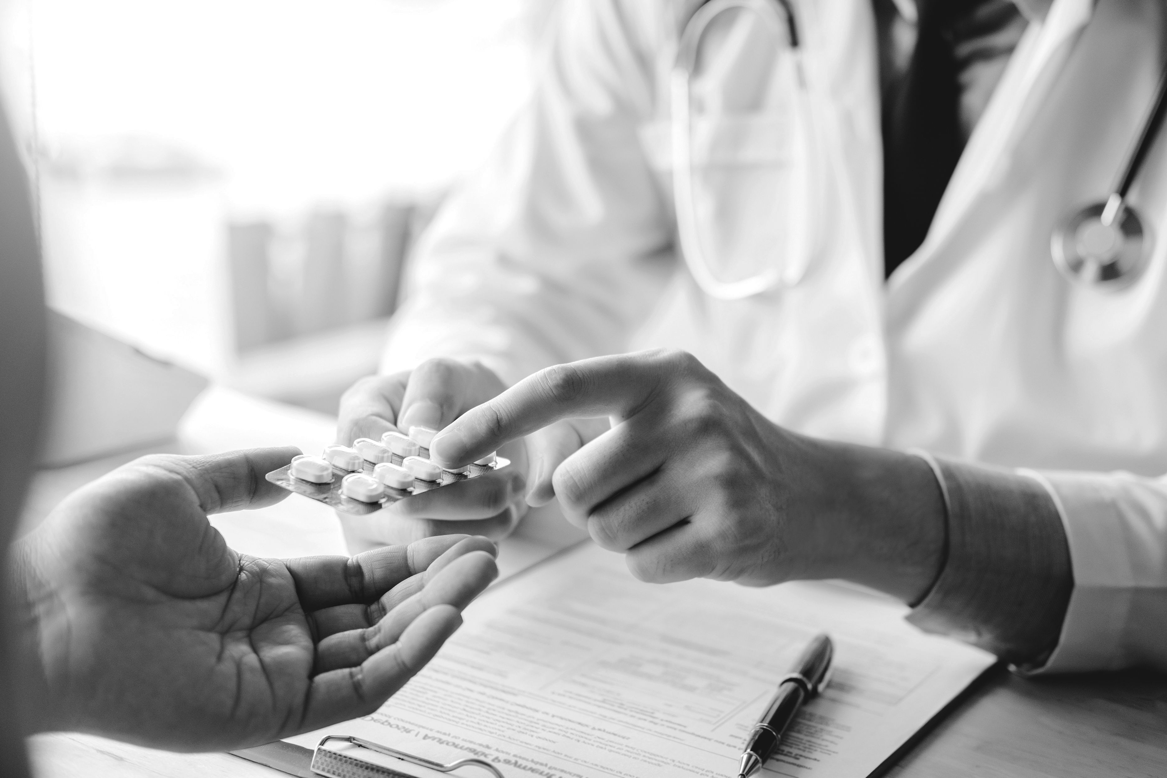 A doctor explaining cholesterol lowering medication to a patient.