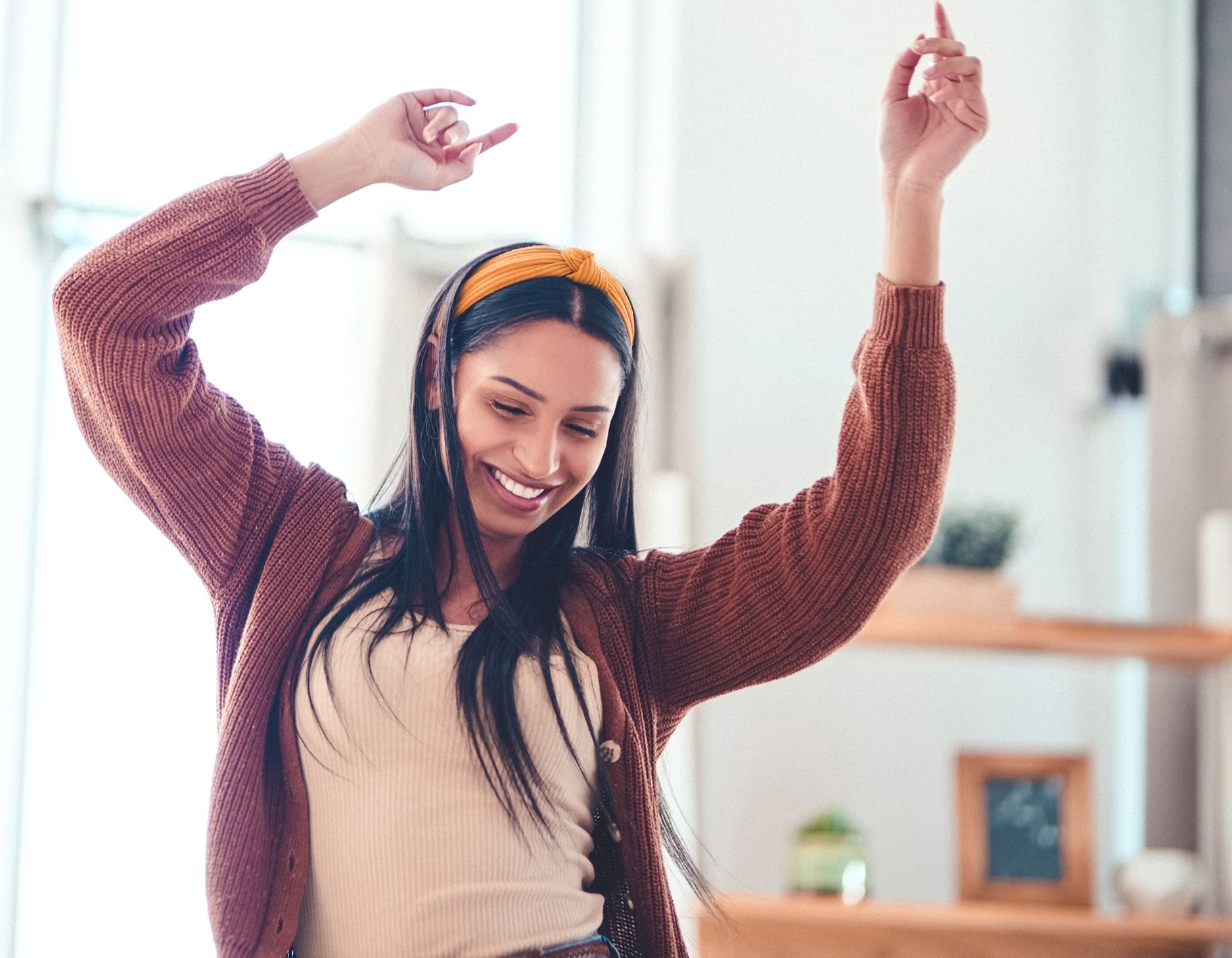 A woman dancing in her kitchen.