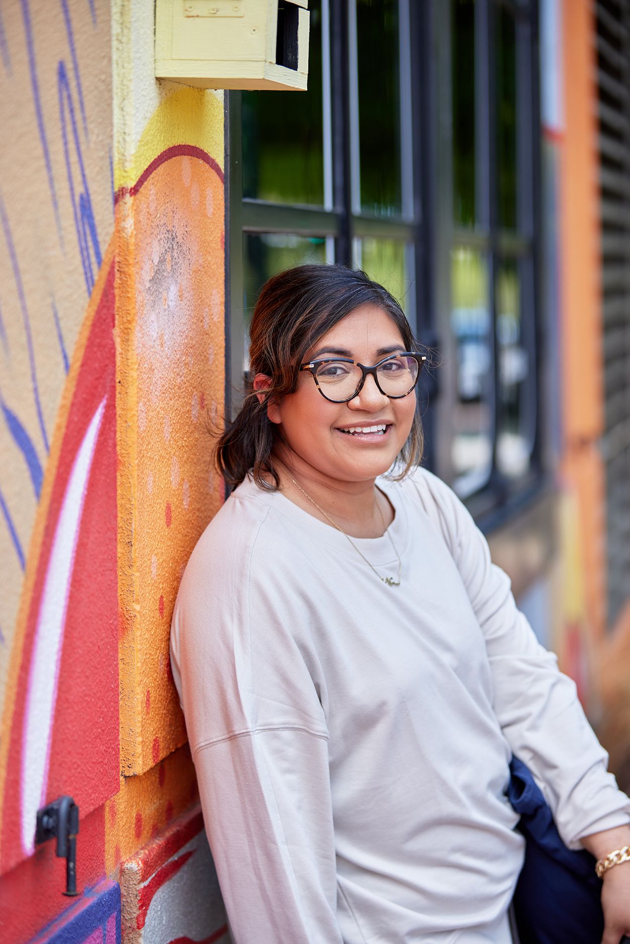 A photo of Alejandra (Ally) Lavalley posing on the street.