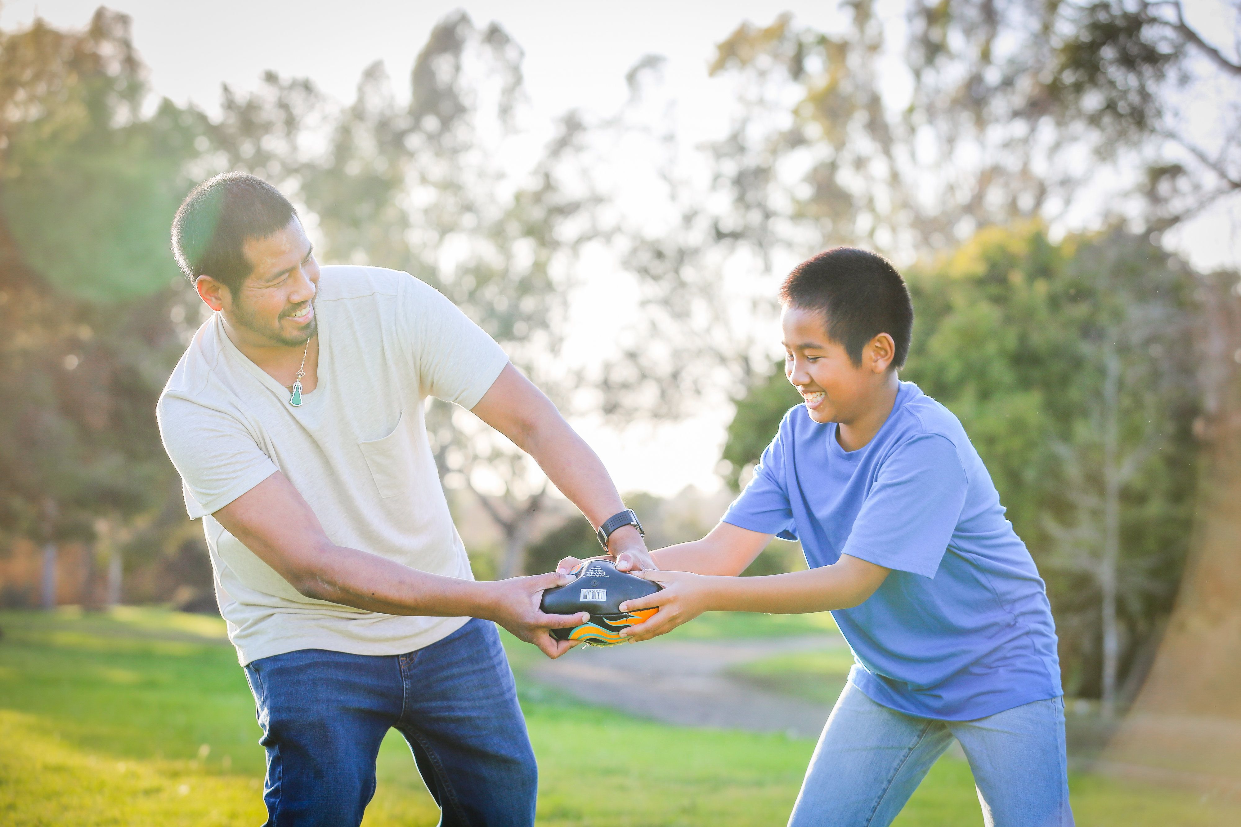 An image of father and son playing outside.
