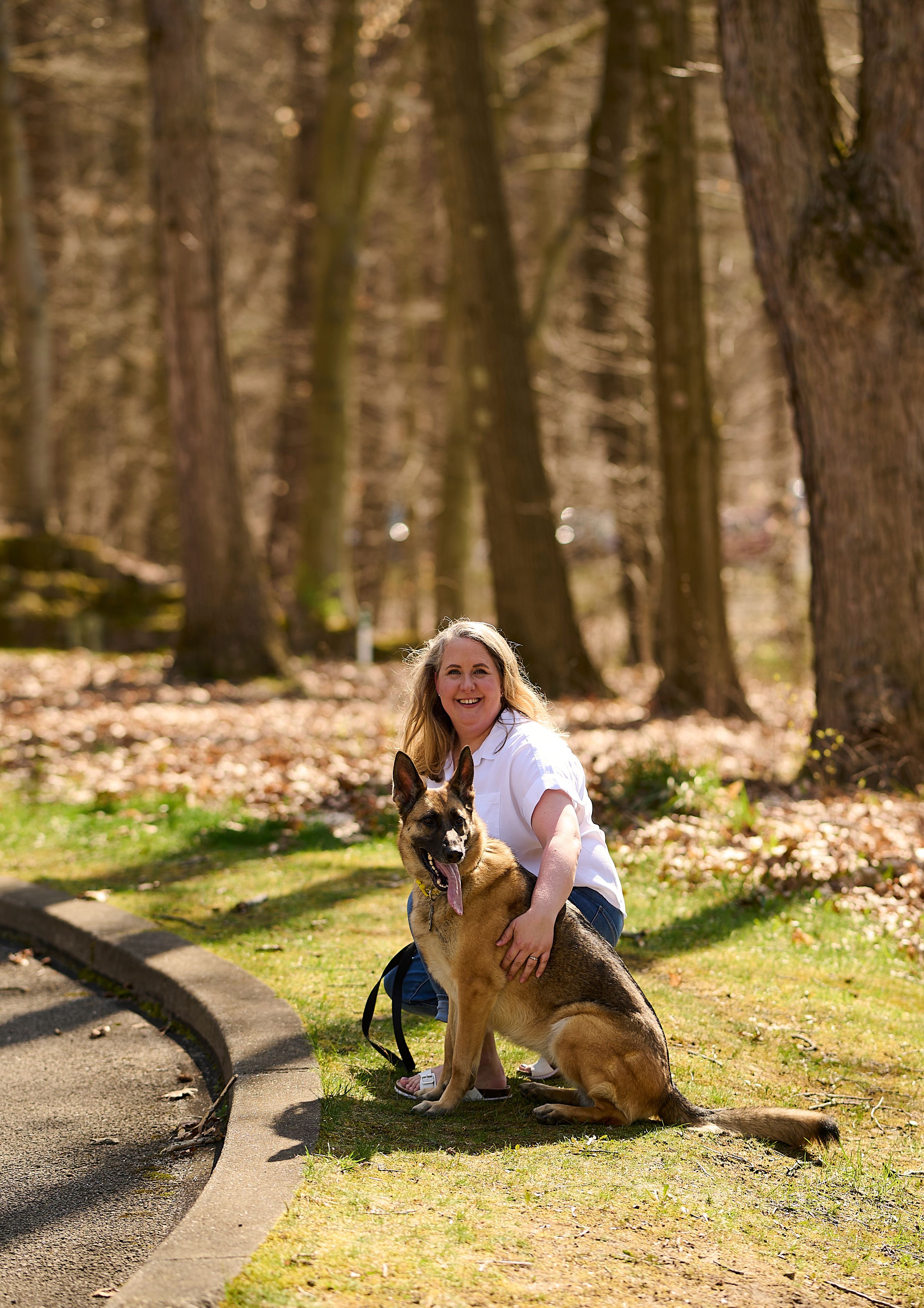 An image of a woman with plaque psoriasis outside with her dog.
