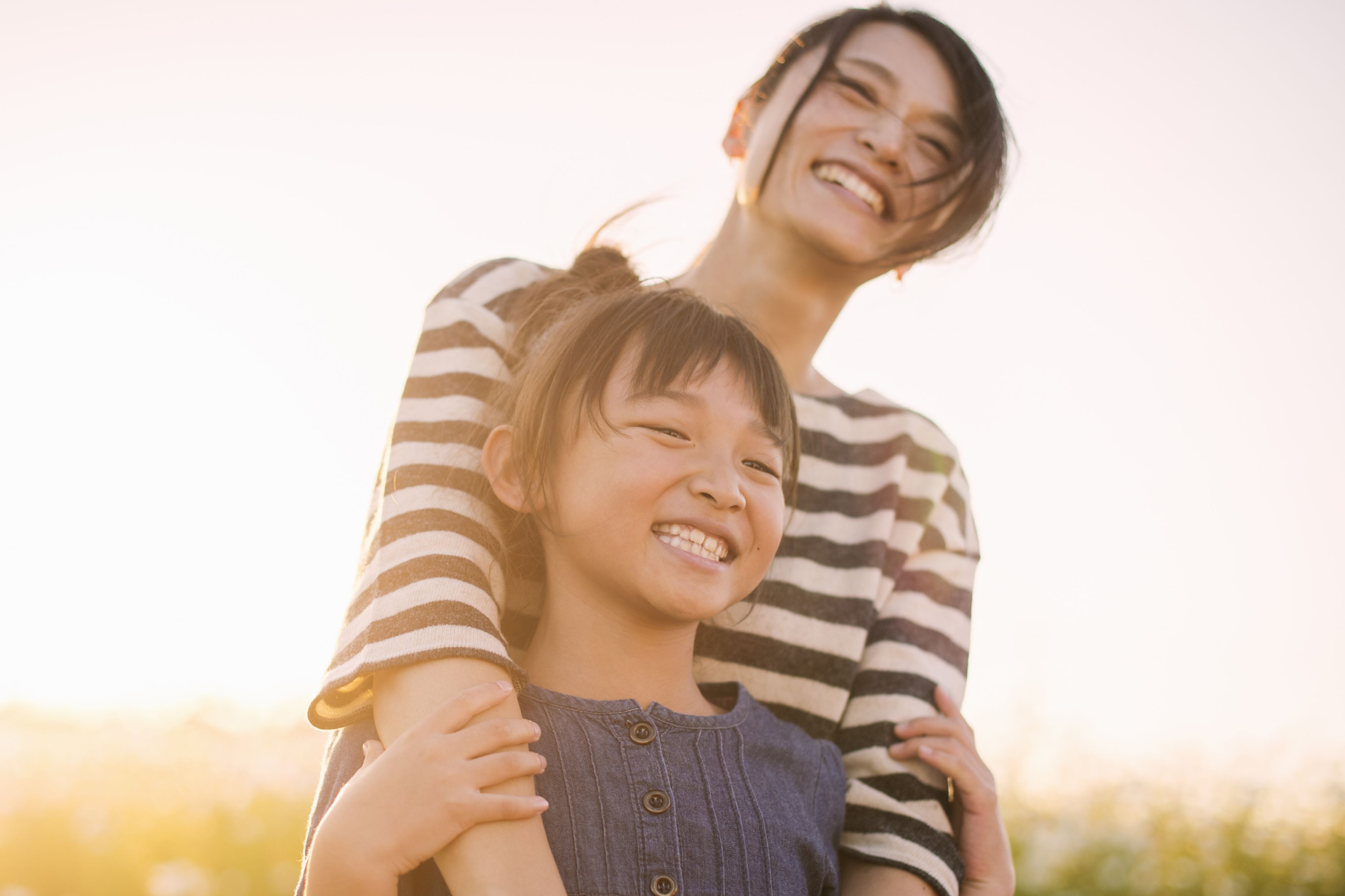 An image of a mother and daughter walking outside.