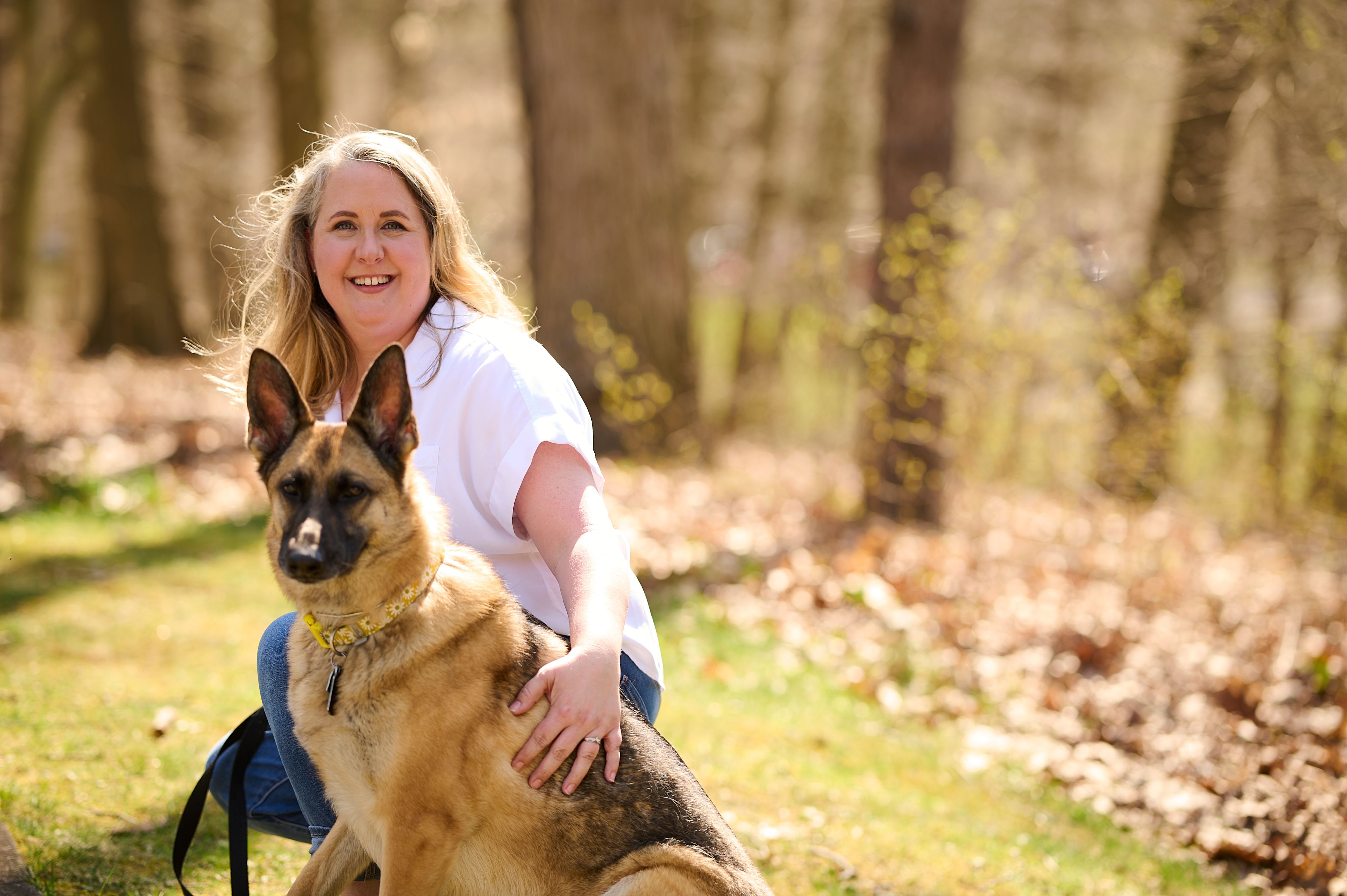 An image of a woman outside with her dog.