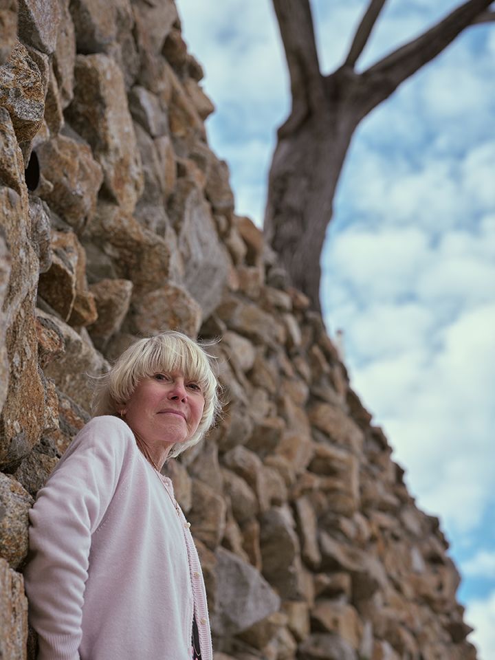 An image of a woman posing outside.